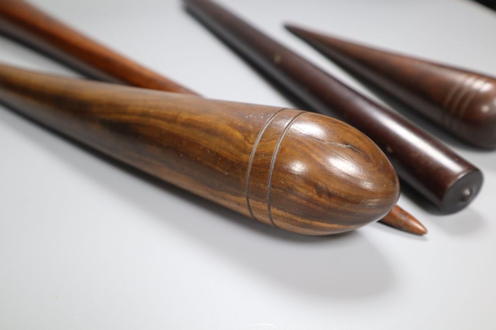 Three 19th century lignum vitae fids and a similar rule, longest 45.5cm